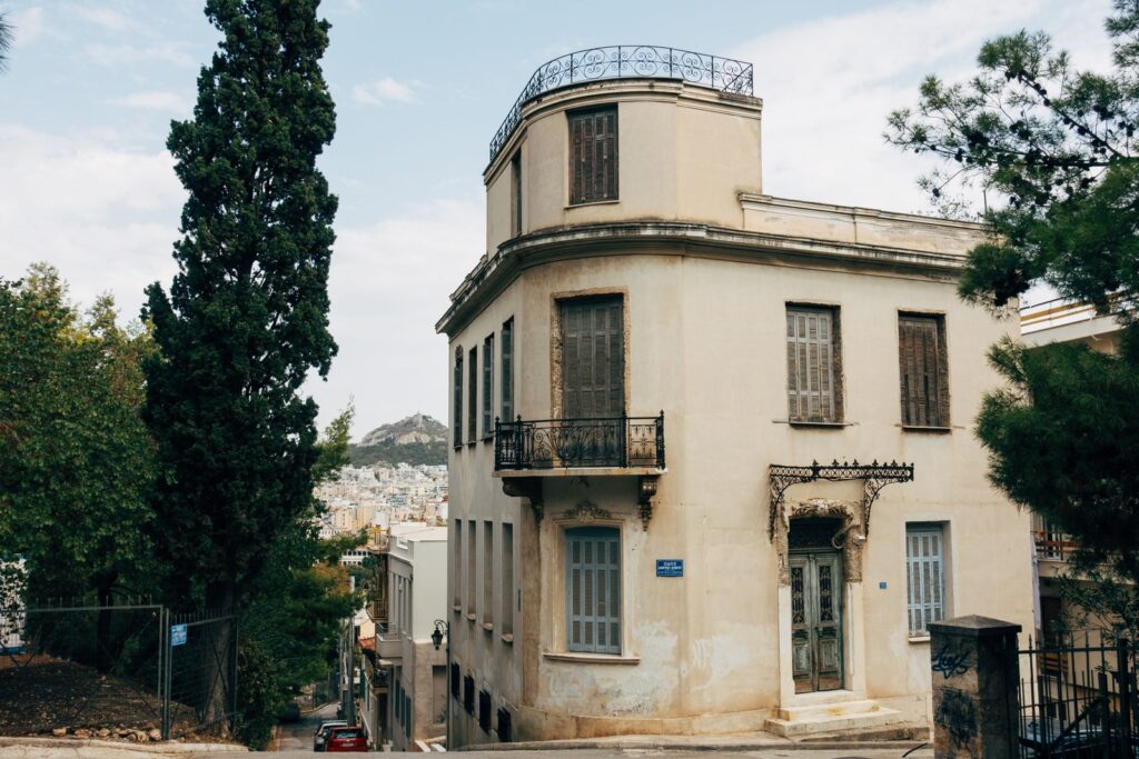 Corner apartment building with balconies on an Athens street