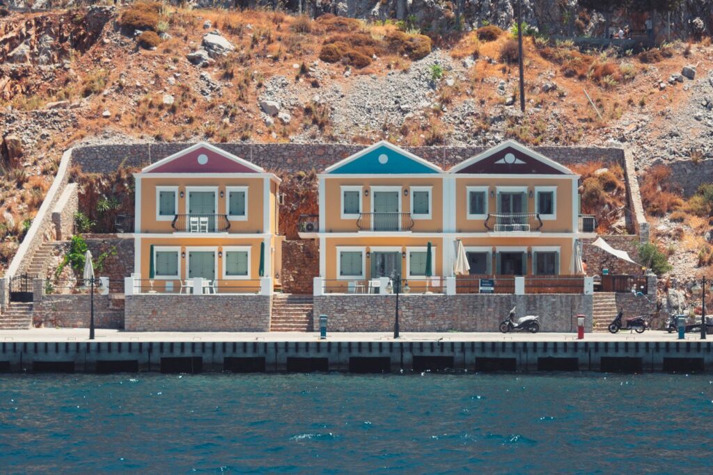 Colourful neoclassical houses on the hillside above the harbour on Symi, Greece