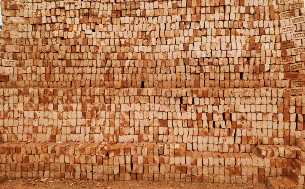 Close-up of a stack of red clay bricks used for construction
