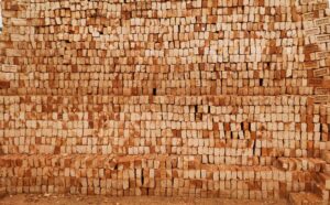 Close-up of a stack of red clay bricks used for construction