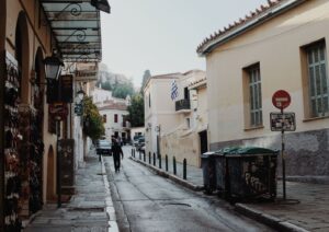 Quiet street with neoclassical houses in the Plaka district of central Athens, with a Greek flag