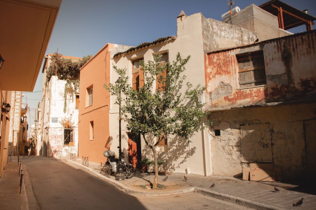 Sunlit street in central Athens lined with older residential buildings