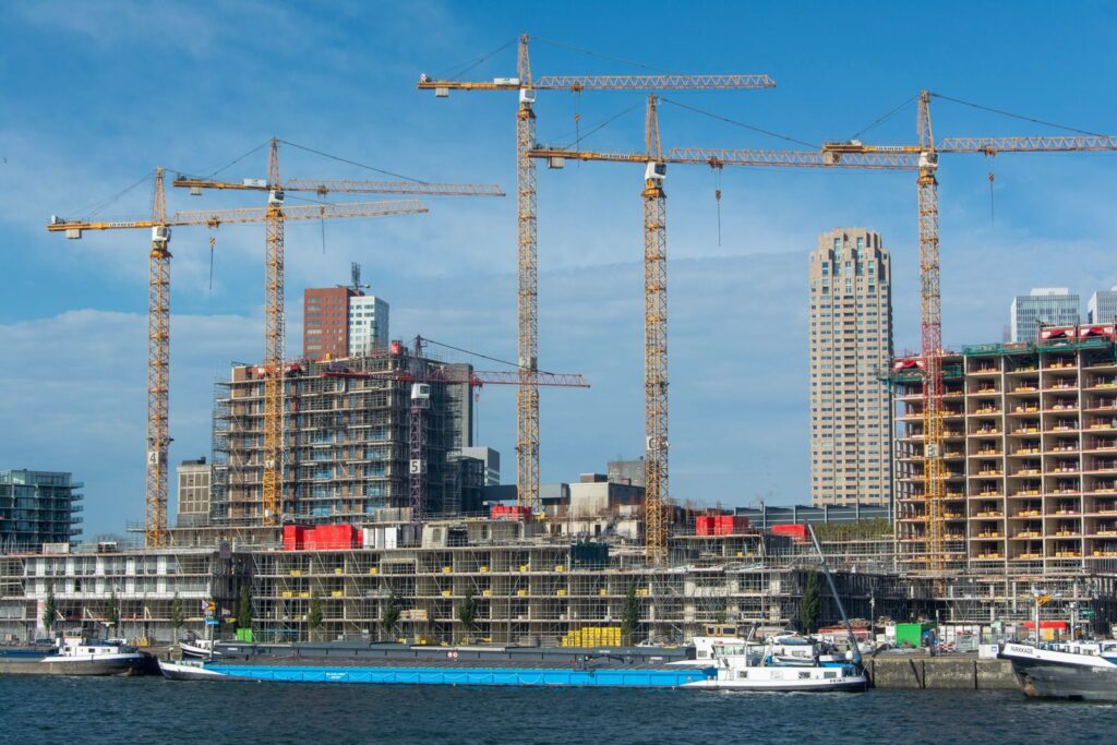 Tower cranes over buildings under construction at an urban development site